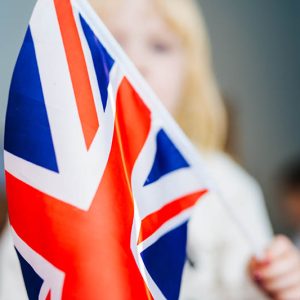 Little girl with flag of United Kingdom. Learn English. Schoolgirl, study abroad, international language courses. Flag of Great Britain.